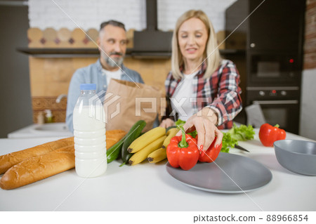 Caucasian family cooking on kitchen from fresh organic food Caucasian family cooking on kitchen from fresh organic food 88966854