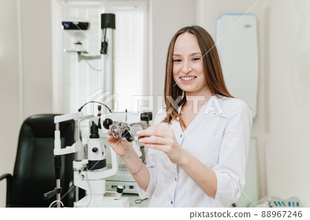 ophthalmologist with trial frame for selection of glasses, examination ophthalmologist with trial frame for selection of glasses, examination 88967246