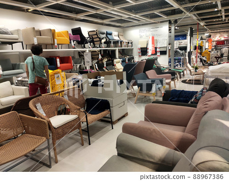 SELANGOR, MALAYSIA - JULY 4, 2022: Sofa furniture and chairs in the IKEA showroom in Malaysia. The furniture is well arranged to make it easy for customers to see and inspect it before buying. 88967386