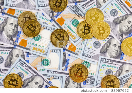 yellow bitcoin coins scattered over US dollar paper banknotes yellow bitcoin coins scattered over US dollar paper banknotes 88967632