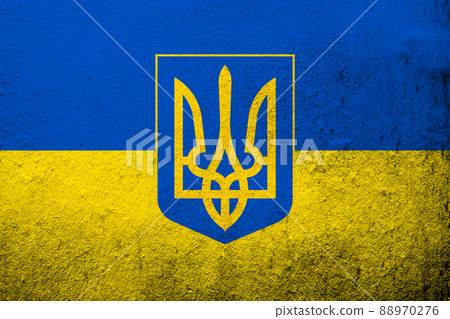 Ukrainian national flag with Coat of arms of Ukraine tryzub. Grunge background 88970276