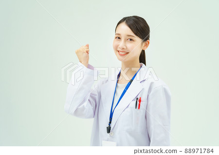 A woman in a white coat doing a guts pose A woman in a white coat doing a guts pose 88971784