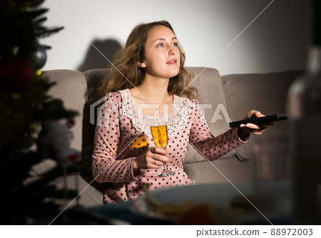 Smiling woman watching tv 88972003