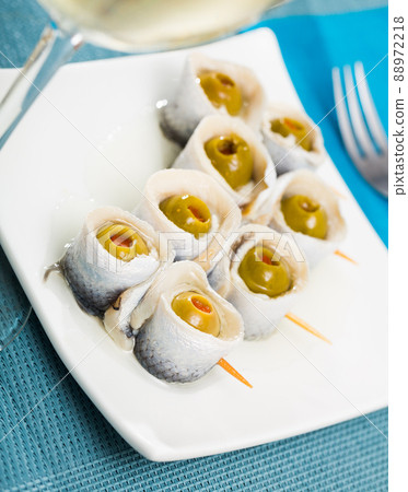 Herring rolls with stuffed olives 88972218