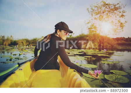 woman sailing sea kayak in lotus flower lagoon 88972300