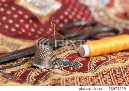 Golden Thread and Thimble on Vintage Fabric From The Middle East 88973359