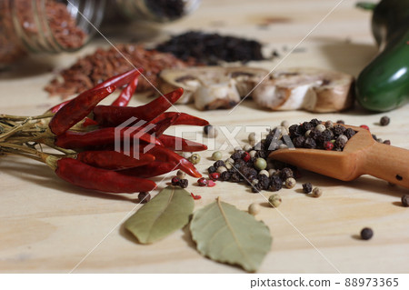 Dried Peppers With Spices and Jars of Rice in Background in Rustic Kitchen Dried Peppers With Spices and Jars of Rice in Background in Rustic Kitchen 88973365
