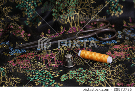 Yellow Thread and Thimble on Vintage Chinese Black Silk Yellow Thread and Thimble on Vintage Chinese Black Silk 88973756