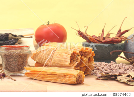 Tamales With Garlic, Beans and Tomato on Yellow Background 88974463