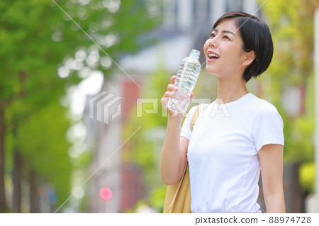 一個微笑的女人用礦泉水 1 88974728