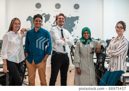Portrait of young excited multiethnics business team of software developers standing and looking at camera at modern startup office 88975437