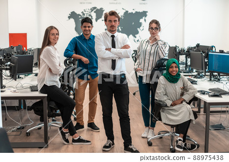 Portrait of young excited multiethnics business team of software developers standing and looking at camera at modern startup office 88975438
