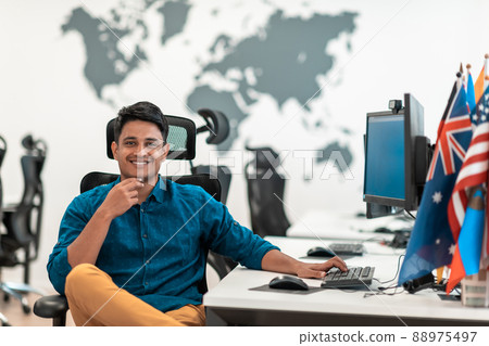 Casual business man working on desktop computer in modern open plan startup office interior. Selective focus Casual business man working on desktop computer in modern open plan startup office interior. Selective focus 88975497