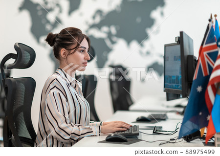Casual business woman working on desktop computer in modern open plan startup office interior. Selective focus Casual business woman working on desktop computer in modern open plan startup office interior. Selective focus 88975499
