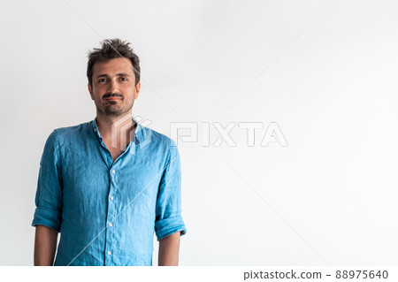 Formal business male portrait. A confident successful casual businessman or manager stands in front of a white background. Formal business male portrait. A confident successful casual businessman or manager stands in front of a white background. 88975640