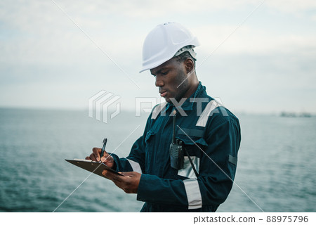 Deck Officer on deck of vessel or ship fills checklist Deck Officer on deck of vessel or ship fills checklist 88975796