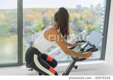 Exercise at home indoor cycling with online Stock Photo