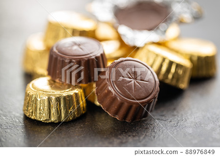 Chocolate pralines. Sweet chocolate bonbons on kitchen table. 88976849