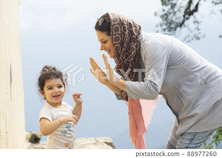 Young Muslim woman playing with her girl 88977260