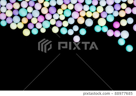 Foam beads of various colors brightly colored on black color background with empty space. 88977685