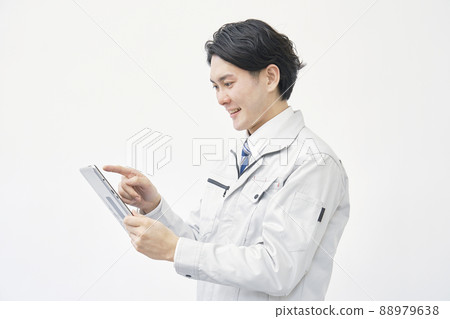 Worker working tablet white background Worker working tablet white background 88979638
