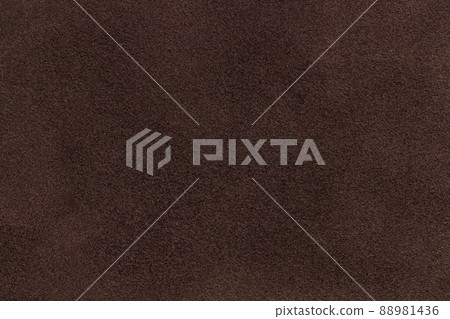 Background of dark brown suede matte fabric. Velvet matt texture of umber nubuck textile. Velveteen pattern. 88981436