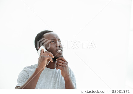 handsome guy with smartphone looking at copy space. handsome guy with smartphone looking at copy space. 88981571