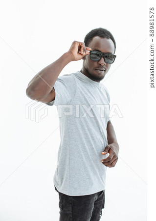 handsome guy looking intently through sunglasses . isolated on white 88981578