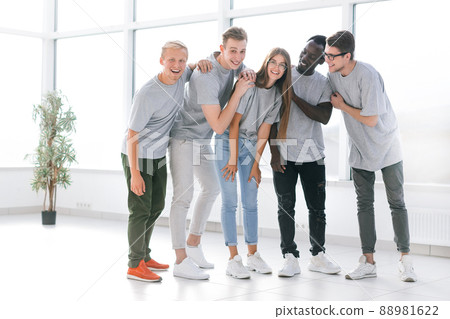 team of young professionals standing in a bright office 88981622