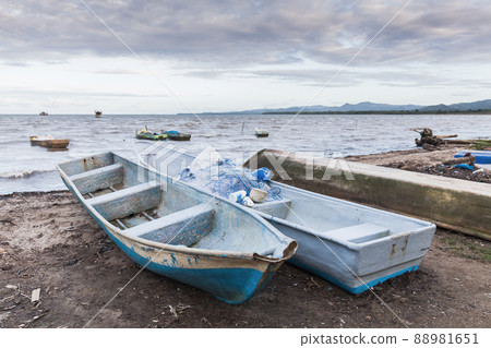 Small boats lay on the coast of Samana Bay 88981651