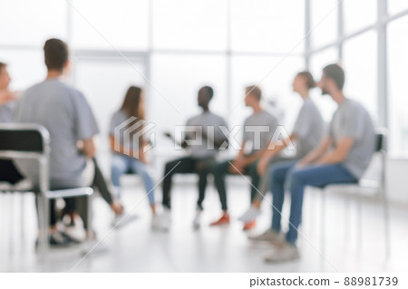 background image of a group of young people at a meeting in a conference room 88981739