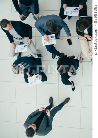 top view. Manager asks questions during a business meeting. 88981865