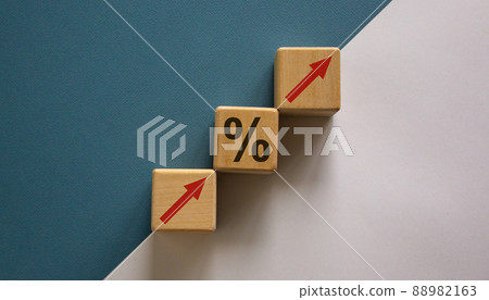 Business concept growth success process. Wood block with arrows and percent signs stacking as step stair on paper blue and white background, copy space. Business concept growth success process. Wood block with arrows and percent signs stacking as step stair on paper blue and white background, copy space. 88982163