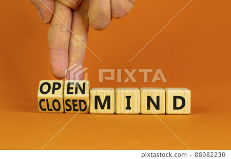 Open or closed mind symbol. Businessman turns cubes and changes concept words closrd mind to open mind. Beautiful orange table, orange background, copy space. Business open or closed mind concept. 88982230