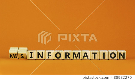 Information or misinformation symbol. Turned cubes and changed the word misinformation to information. Orange background, copy space. Business and information or misinformation concept. Information or misinformation symbol. Turned cubes and changed the word misinformation to information. Orange background, copy space. Business and information or misinformation concept. 88982270