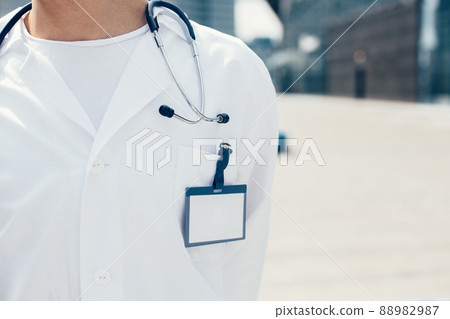 close up. male paramedic with a badge on his white coat. close up. male paramedic with a badge on his white coat. 88982987