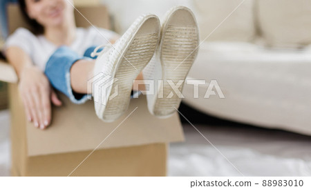 young couple unpacking boxes in new apartment 88983010