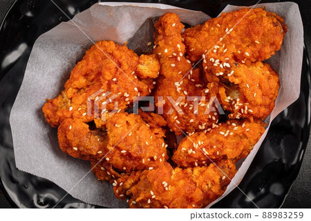 Closeup on crispy fried chicken wings Closeup on crispy fried chicken wings 88983259