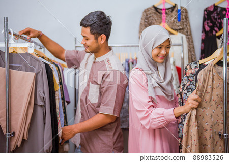 muslim woman shopping some dress for idul fitri with her husband 88983526