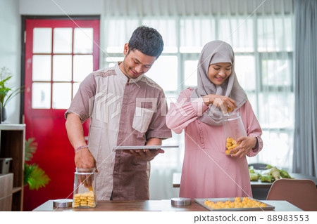 muslim man and woman bake nastar snack for idul fitri muslim man and woman bake nastar snack for idul fitri 88983553