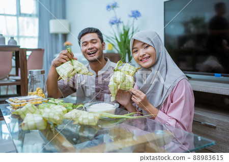 muslim couple asian making ketupat rice cake at home using palm leaf 88983615
