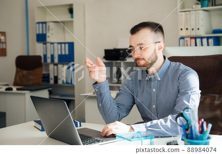 Businessman working on his laptop in an office Businessman working on his laptop in an office 88984074