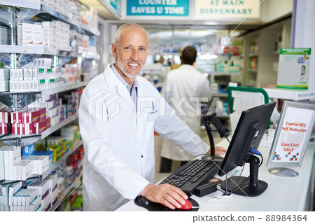 Here to help keep you in your best health. Portrait of a mature pharmacist working on a computer in a chemist. Here to help keep you in your best health. Portrait of a mature pharmacist working on a computer in a chemist. 88984364