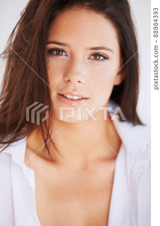 Naturally beautiful. A stunning young woman wearing only a shirt giving you a smoldering look. 88984393