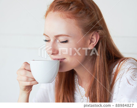 Theres nothing like fresh coffee in the morning. Cropped shot of a young woman drinking coffee at a cafe. Theres nothing like fresh coffee in the morning. Cropped shot of a young woman drinking coffee at a cafe. 88984827
