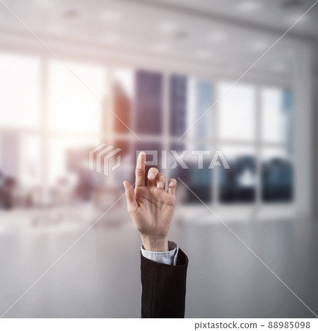 Choosing gesture of businessperson in elegant modern interior in sunshine light 88985098