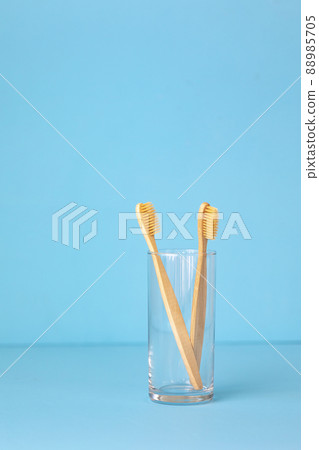bamboo toothbrushes on a blue background in a glass, eco-friendly personal care products for people who care about the breed bamboo toothbrushes on a blue background in a glass, eco-friendly personal care products for people who care about the breed 88985705