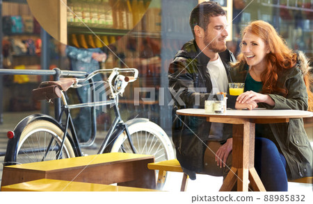 Love and laughter. Cropped shot of a happy young couple on a date at a cafe. Love and laughter. Cropped shot of a happy young couple on a date at a cafe. 88985832