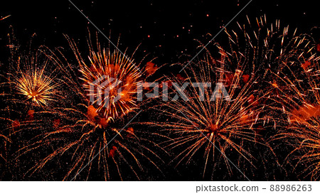 Festive grandiose fireworks festival against the background of the night sky. Multicolored motion blur splashes of fire . Pyrotechnics. Festive grandiose fireworks festival against the background of the night sky. Multicolored motion blur splashes of fire . Pyrotechnics. 88986263