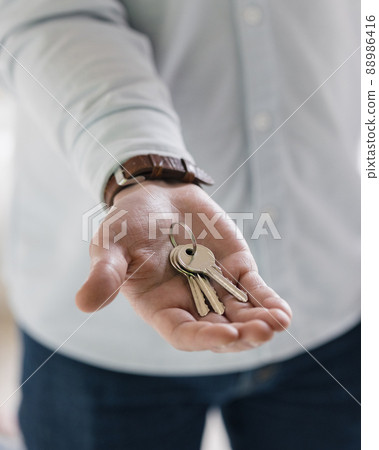the keys to a new apartment or house, a woman or a man holds a bunch of keys or one key in his hand 88986416
